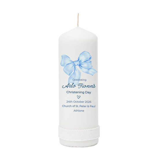 White candle with a blue bow and personalized text on a white background