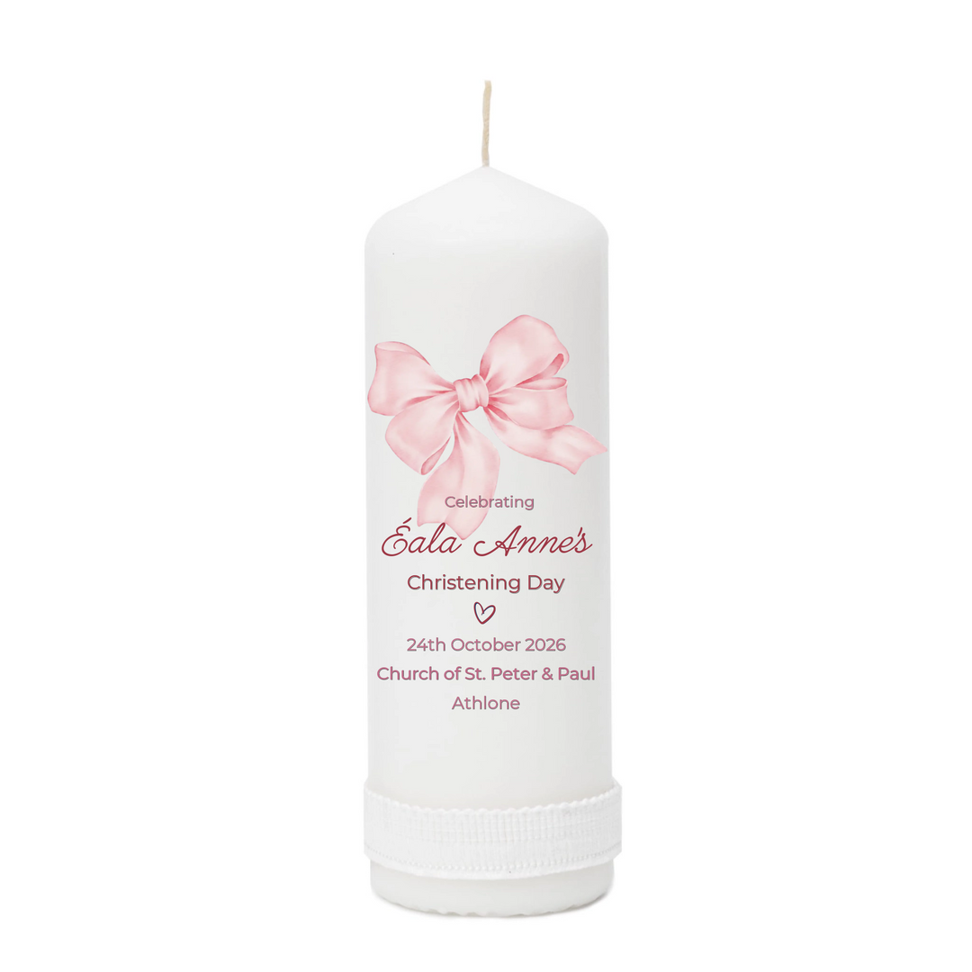 White candle with pink bow design and personalized text on a white background