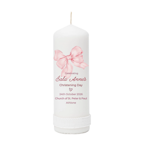 White candle with pink bow design and personalized text on a white background