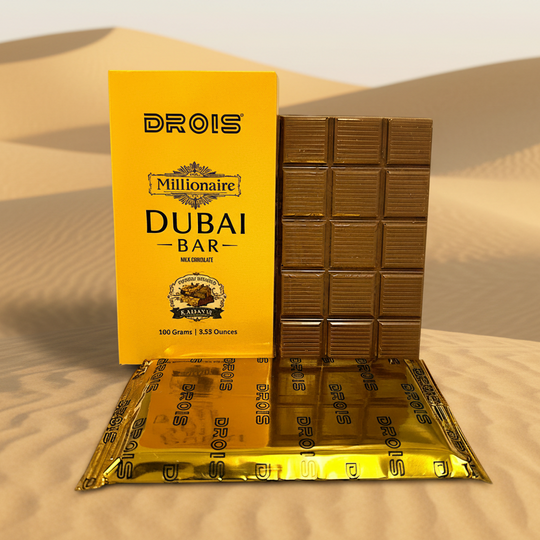 Chocolate bar with gold packaging featuring 'Drois Millionaire Dubai Bar' branding on a white background.