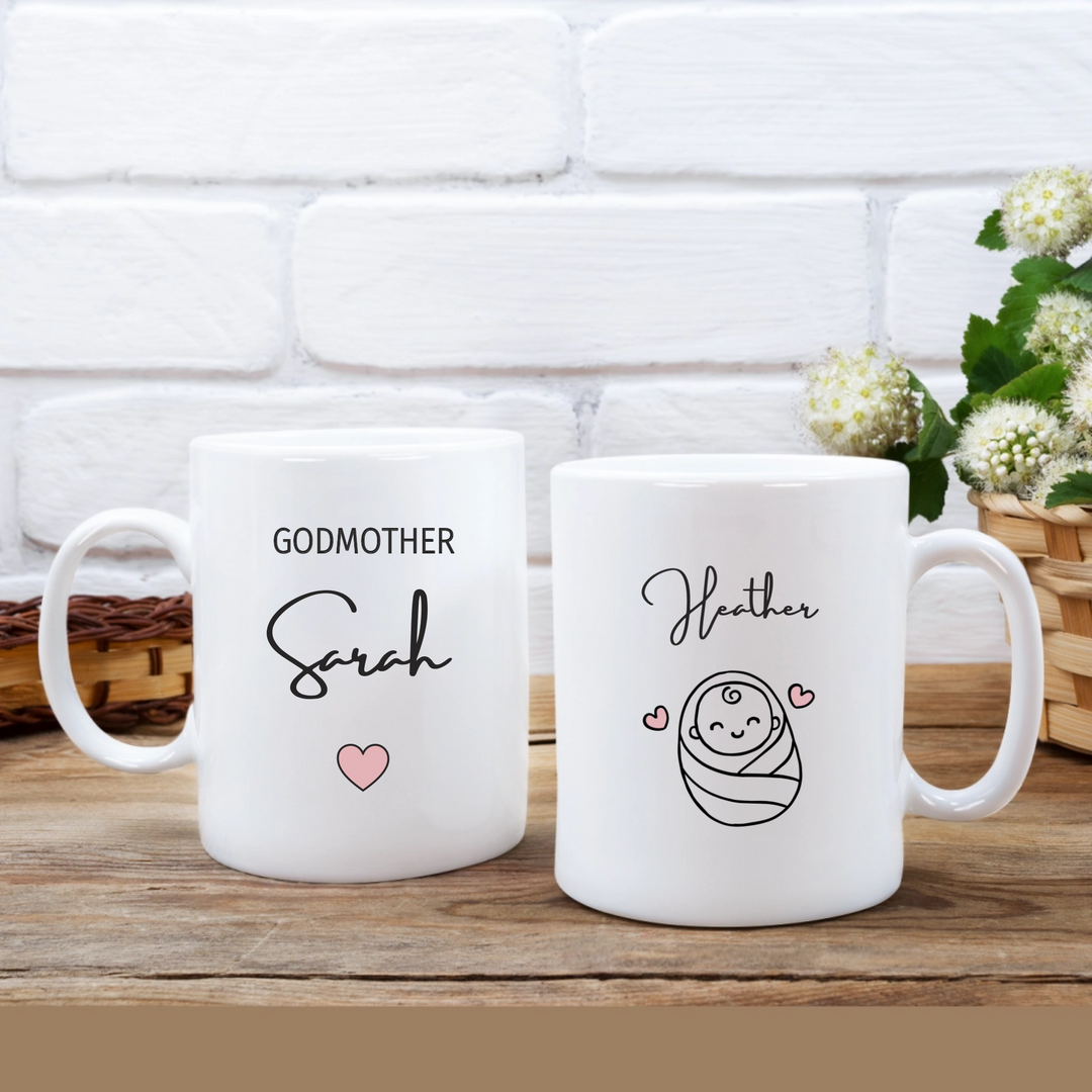 White mug that has godmother and their name. also has baby name and image of a baby