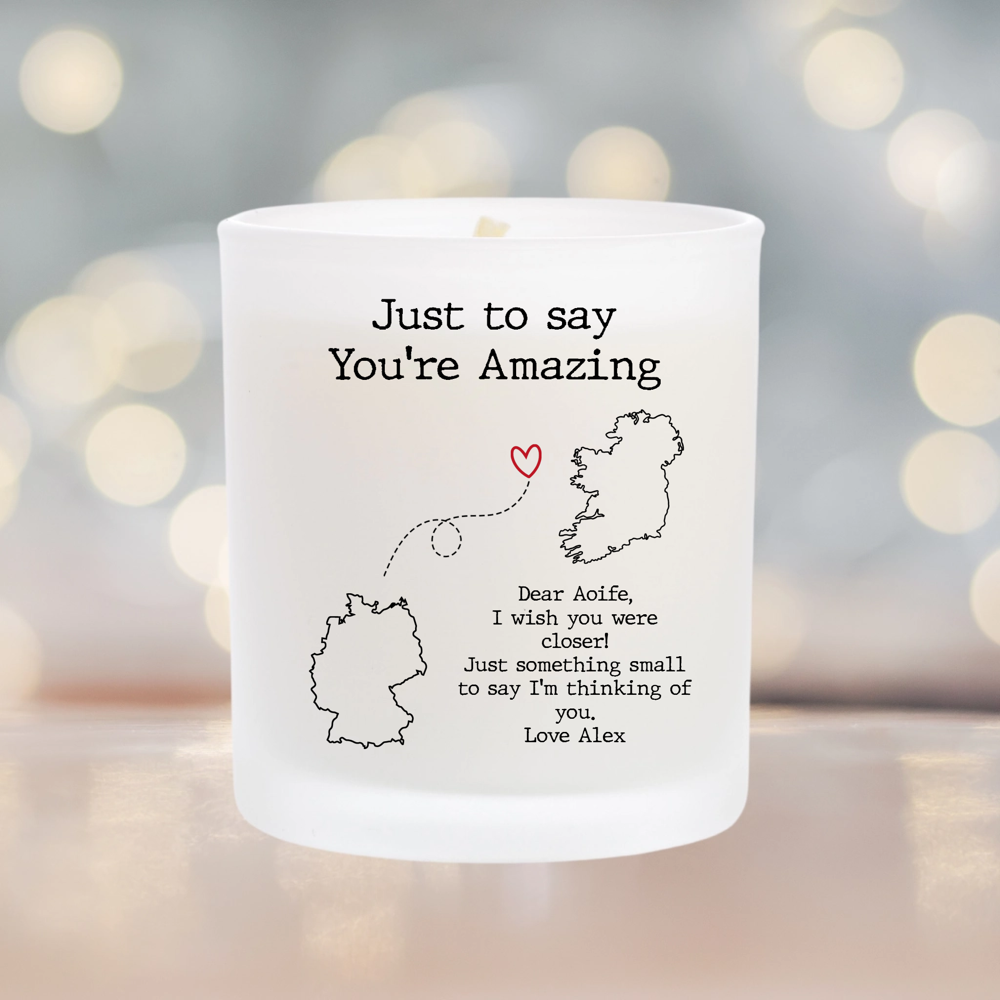 Personalised Scented candle with a personalised sticker. Choose two country maps and add a personal message. a dotted line connects the two countries