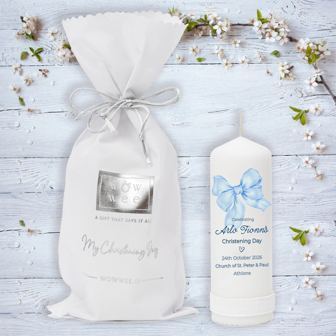Personalized candle and gift bag on a wooden surface with floral decorations