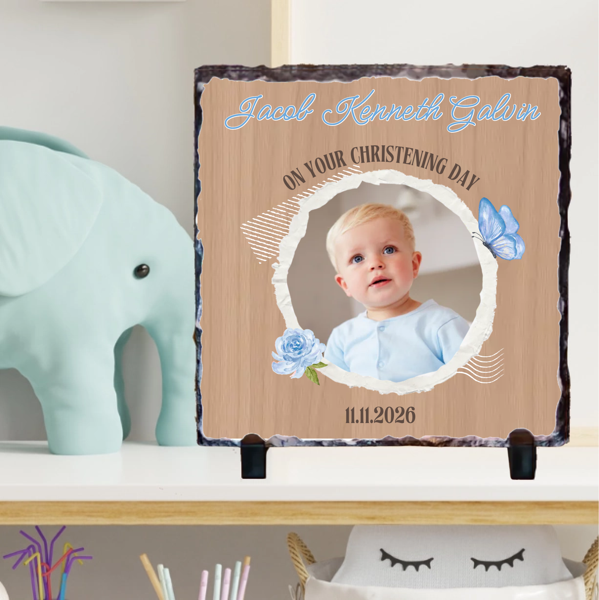 Personalized christening gift with a photo of a baby on a decorative stand.