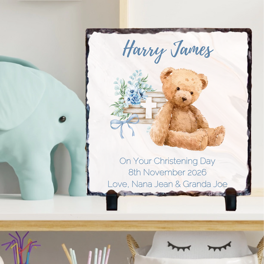Personalized christening gift with teddy bear and floral design on a stand.