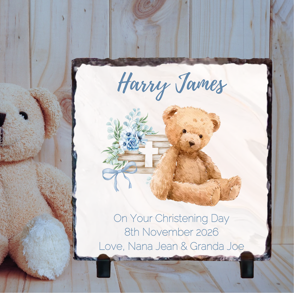 Personalized christening gift with teddy bear and floral design on a wooden background
