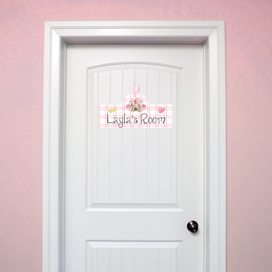 White door with decorative personalised door sign on a pink wall