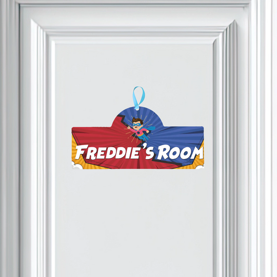 Superhero-themed door sign with 'Freddie's Room' text on a white background