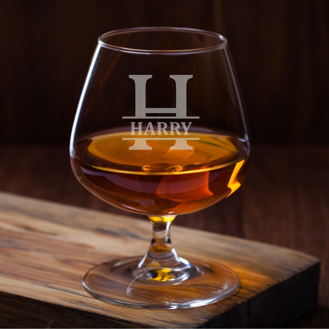 Brandy glass with 'HARRY' engraving on a wooden surface