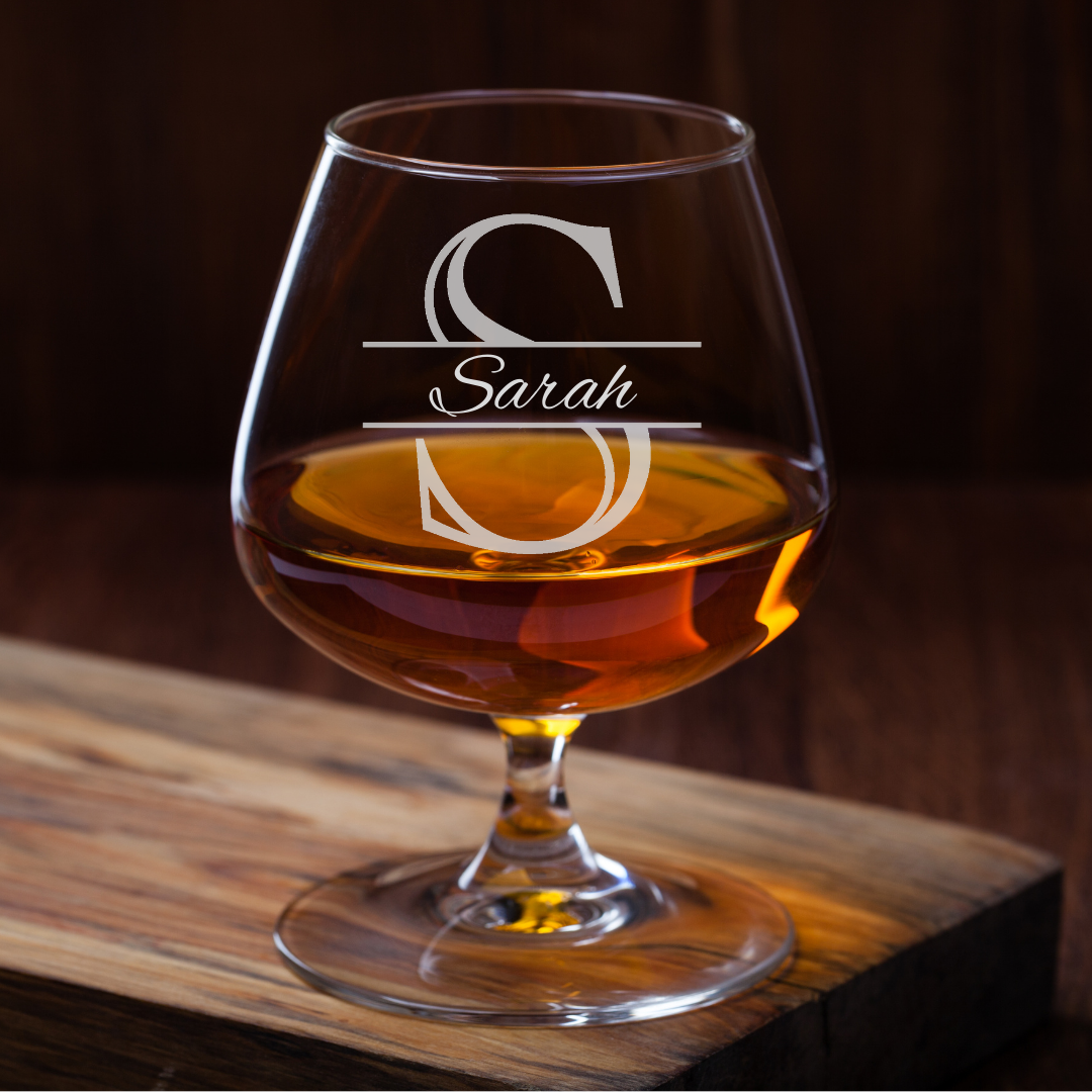 Brandy glass with 'Sarah' engraving on a wooden surface