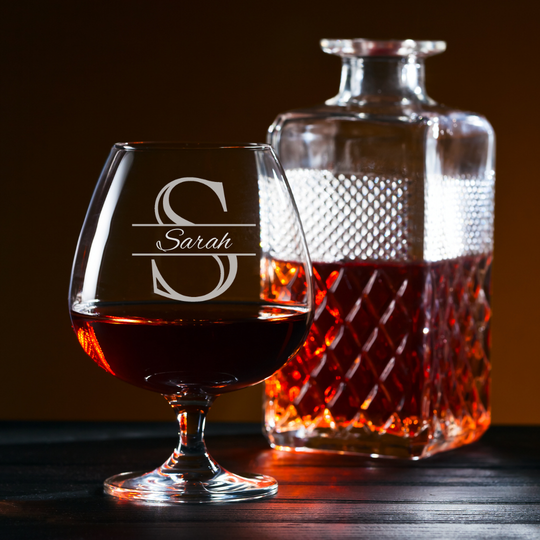 Brandy glass and decanter with 'Sarah' engraving on a dark background