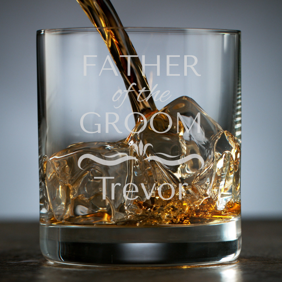 Personalized whiskey glass being filled with whiskey, engraved with 'Father of the Groom Trevor'.