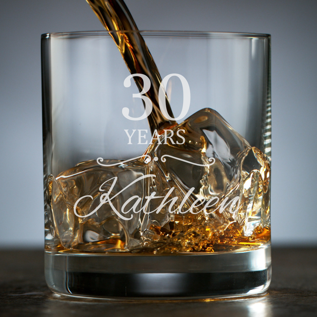 Glass with '30 Years Kathleen' engraving, filled with whiskey.