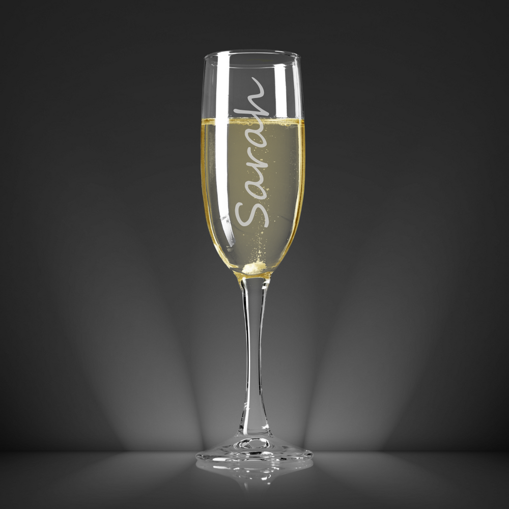 champagne glass with name on it and dark background