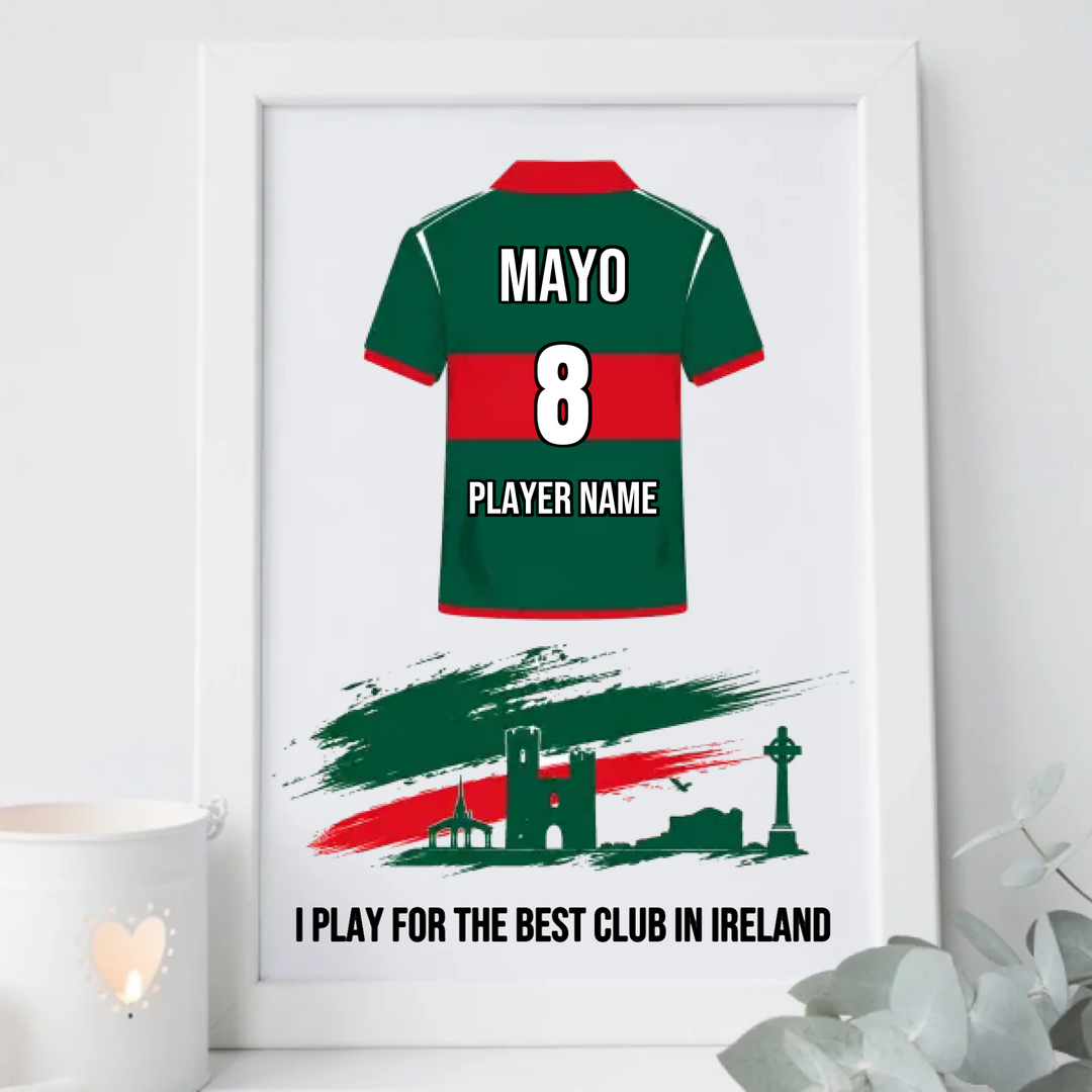 A framed personalized sports jersey print featuring a green and red football shirt with the name MAYO, number 8, and placeholder text, plus a stylized Irish flag and skyline graphic with the slogan 'I PLAY FOR THE BEST CLUB IN IRELAND'.