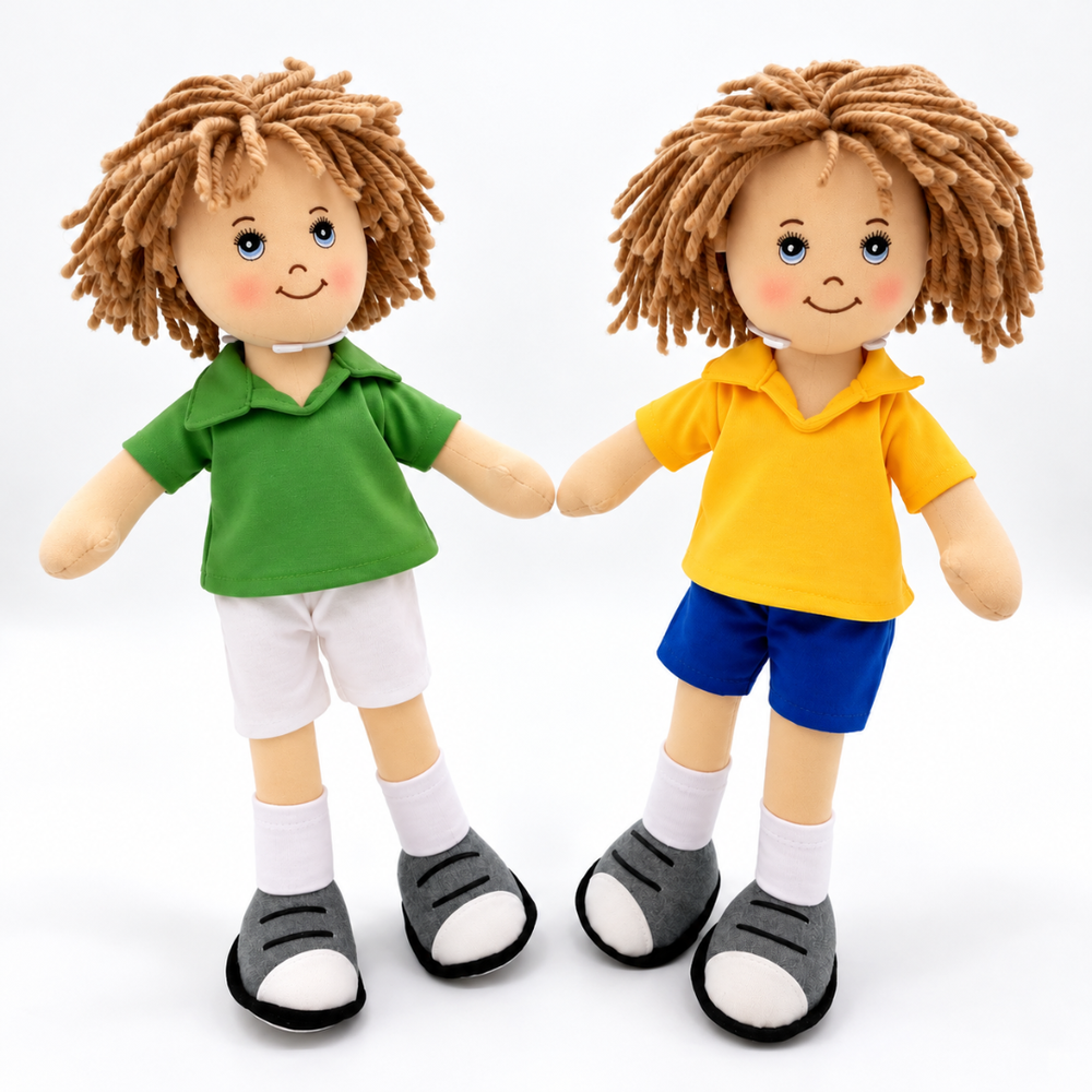 Two plush dolls with brown yarn hair, smiling faces, and colorful outfits. One doll wears a green polo shirt, white shorts, white socks, and gray-and-white shoes.