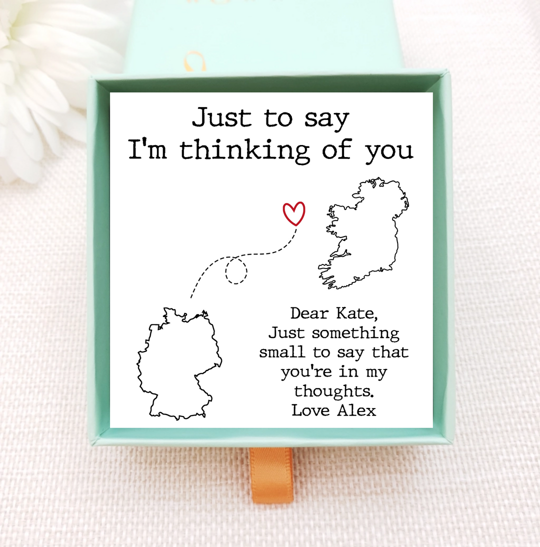 jewellery box insert with necklace. the insert has images of two different countries that are connected by a line. personalise with own image