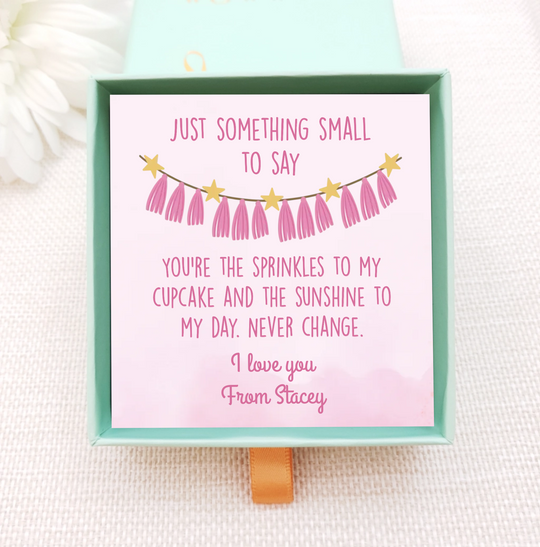 personalised jewellery box insert with gold necklace. the insert is light pink with pink bunting. add own message