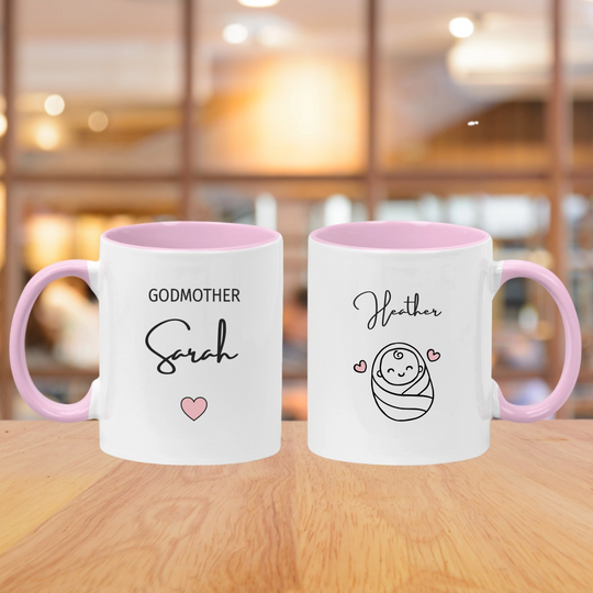White mug with pink handle that has godmother and their name. also has baby name and image of a baby