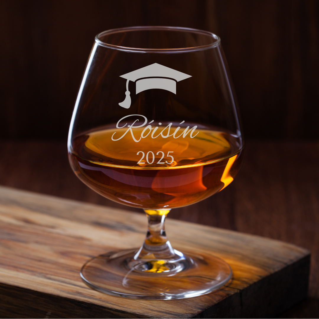 Brandy glass with 'Roisin 2025' engraving on a wooden surface