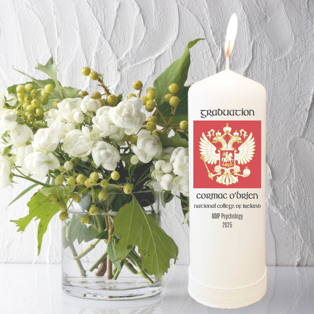 White pillar candle for graduation student. the candle is personalised with their university crest and their own details