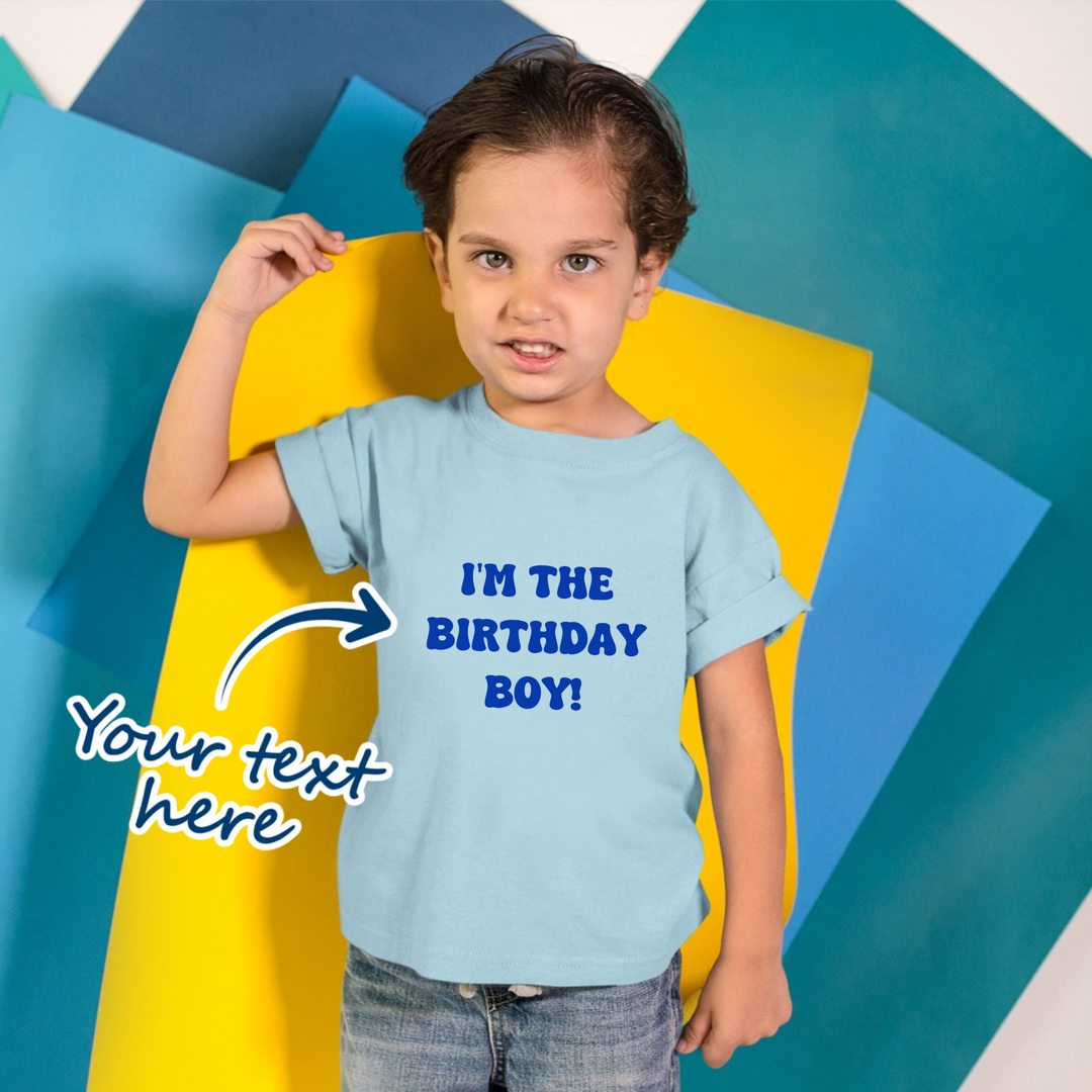 Boy wearing a blue t-shirt that is personalised with their own text. Text is available in various fonts and font colours