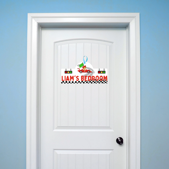 White door with a colorful sign reading 'Liam's Bedroom' on a blue wall.