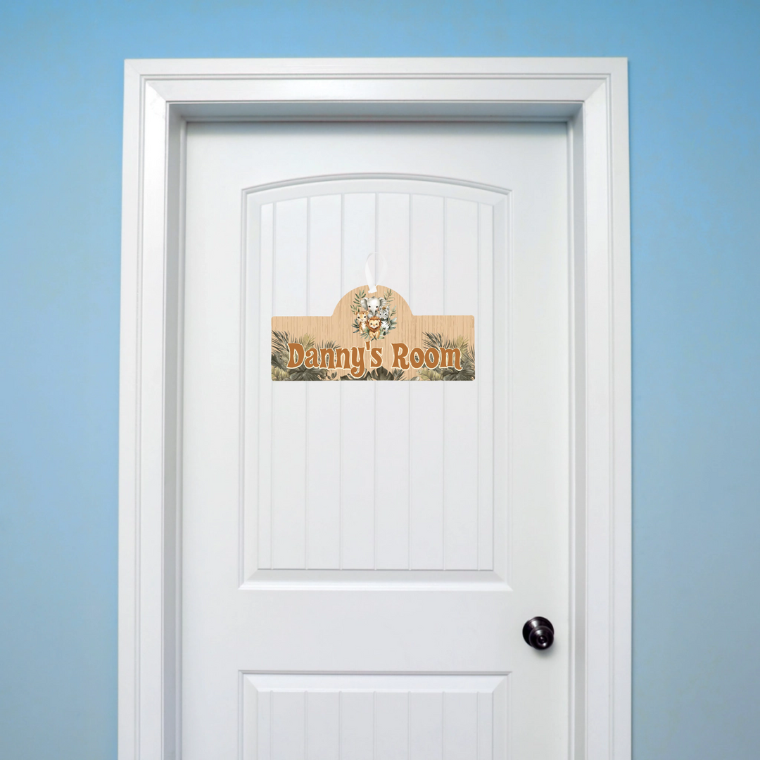 White door with a decorative sign reading 'Danny's Room' against a blue wall.