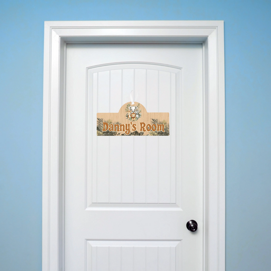 White door with a decorative sign reading 'Danny's Room' against a blue wall.