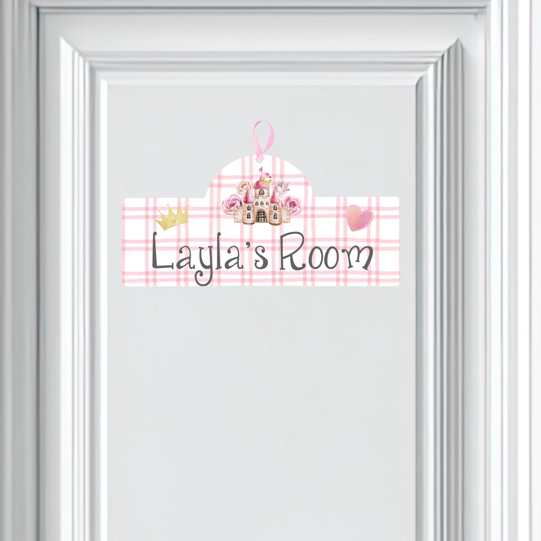 Decorative sign with 'Layla's Room' text on a pink plaid background, framed in white.