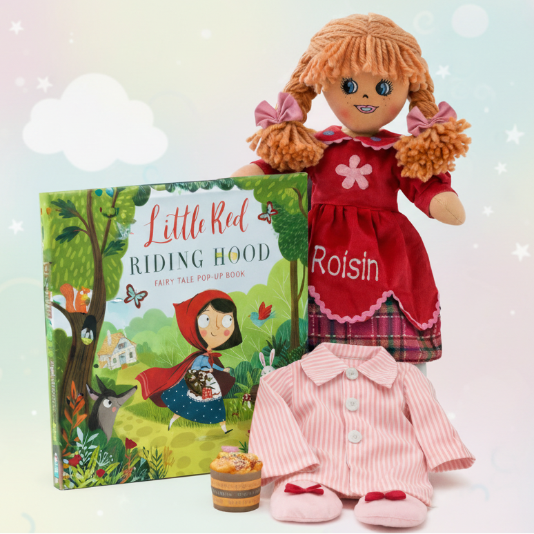 Doll named Poppy in a red dress with a 'Little Red Riding Hood' book on a light background