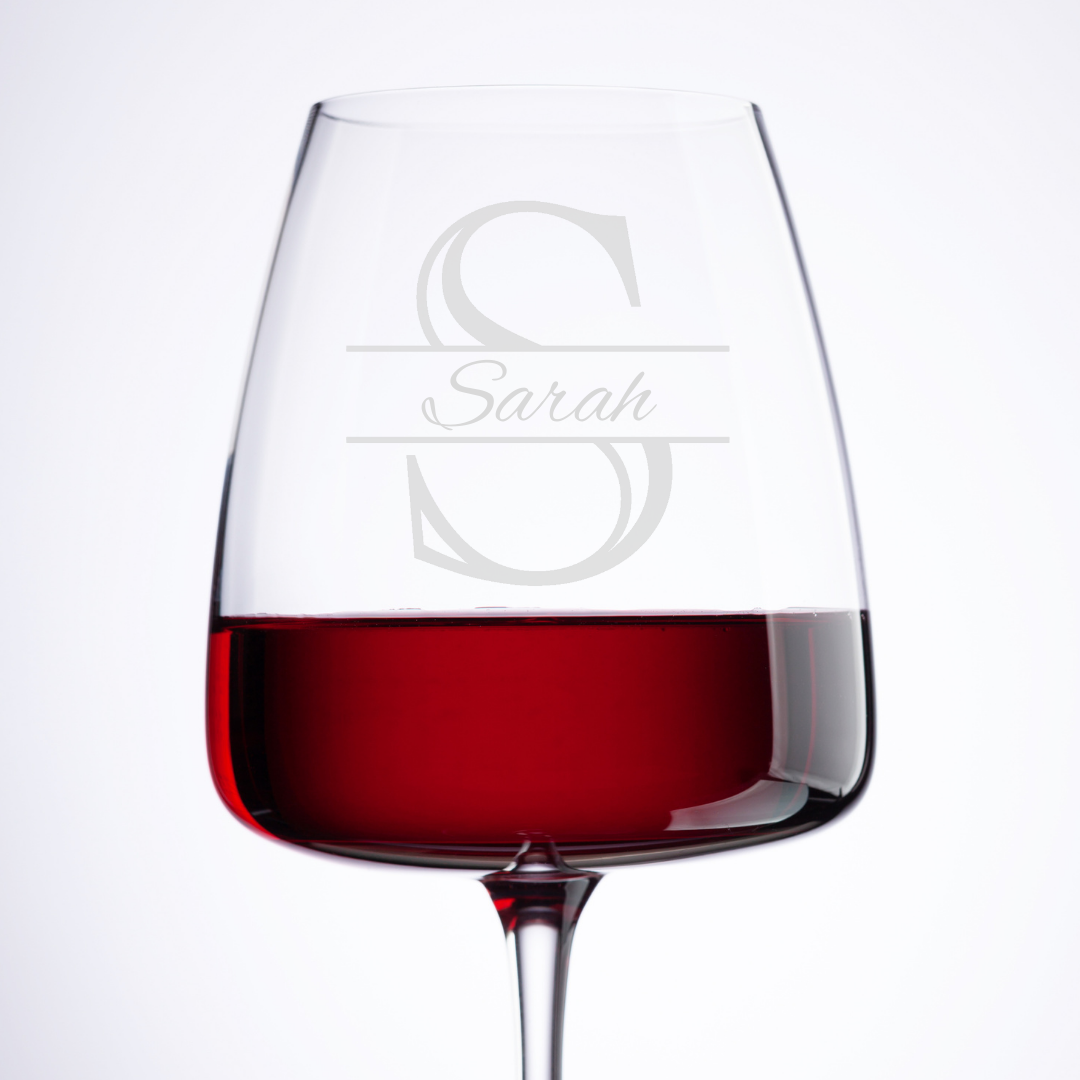 Wine glass with red wine and 'Sarah' engraved on a white background
