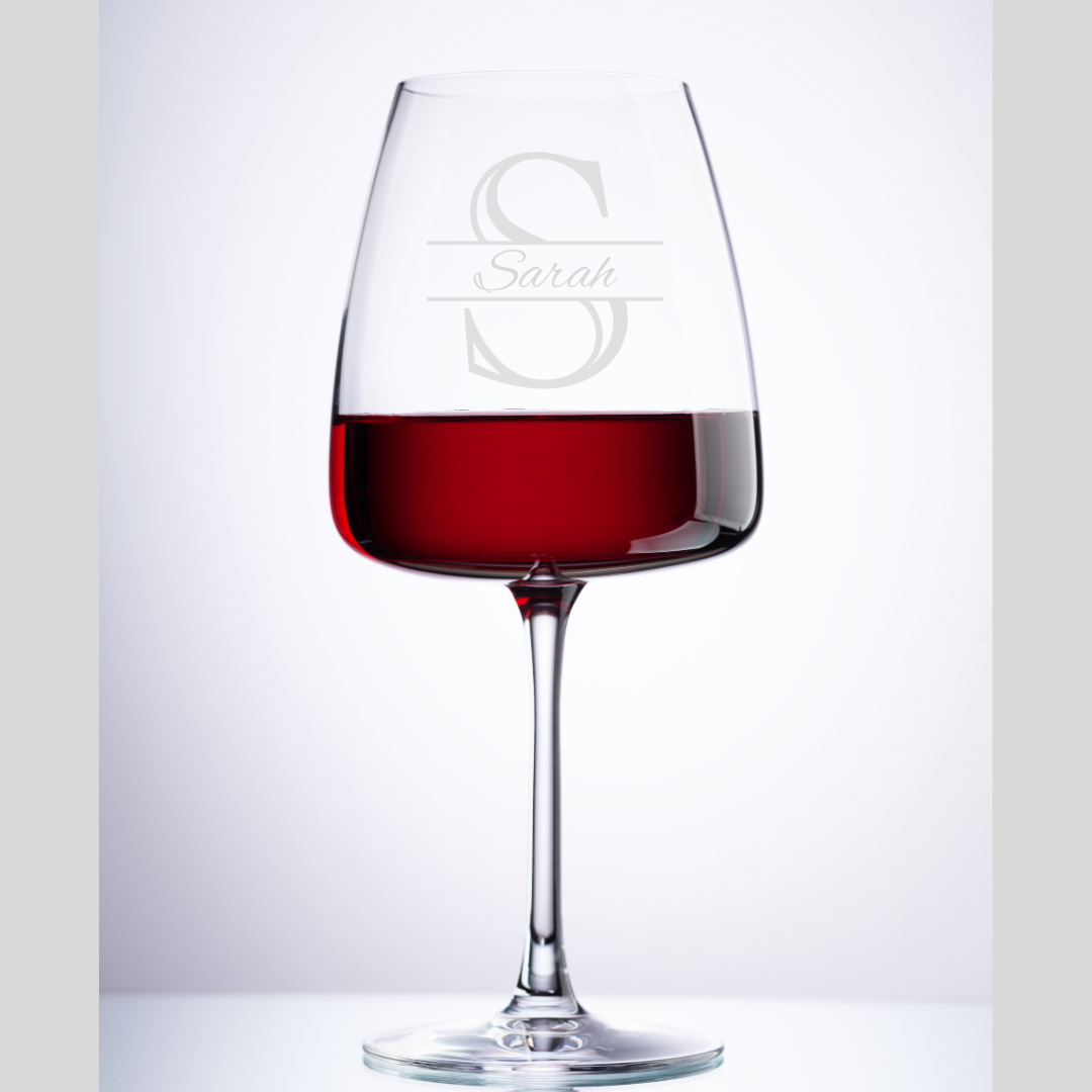 Wine glass with red wine and 'Sarah' engraving on a white background