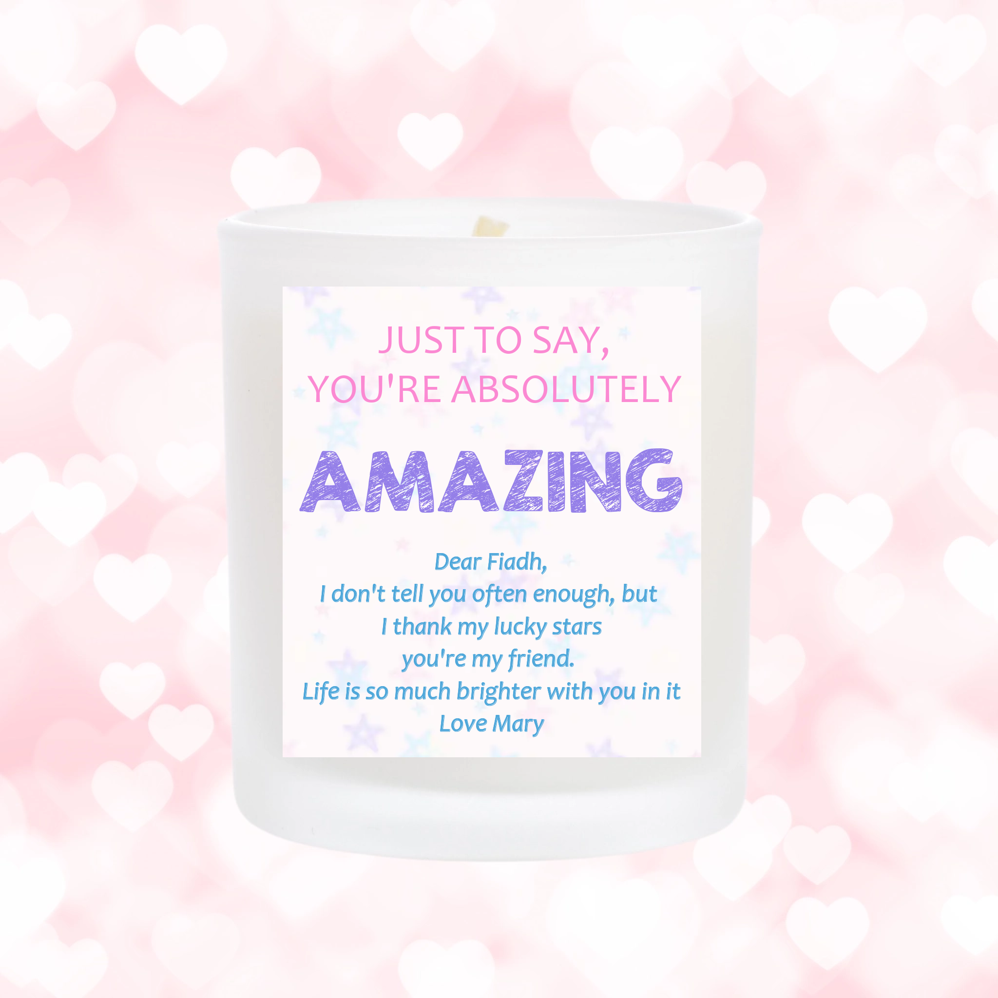 Scented candle with personalised sticker. the sticker is light pink with star designs. add your own message