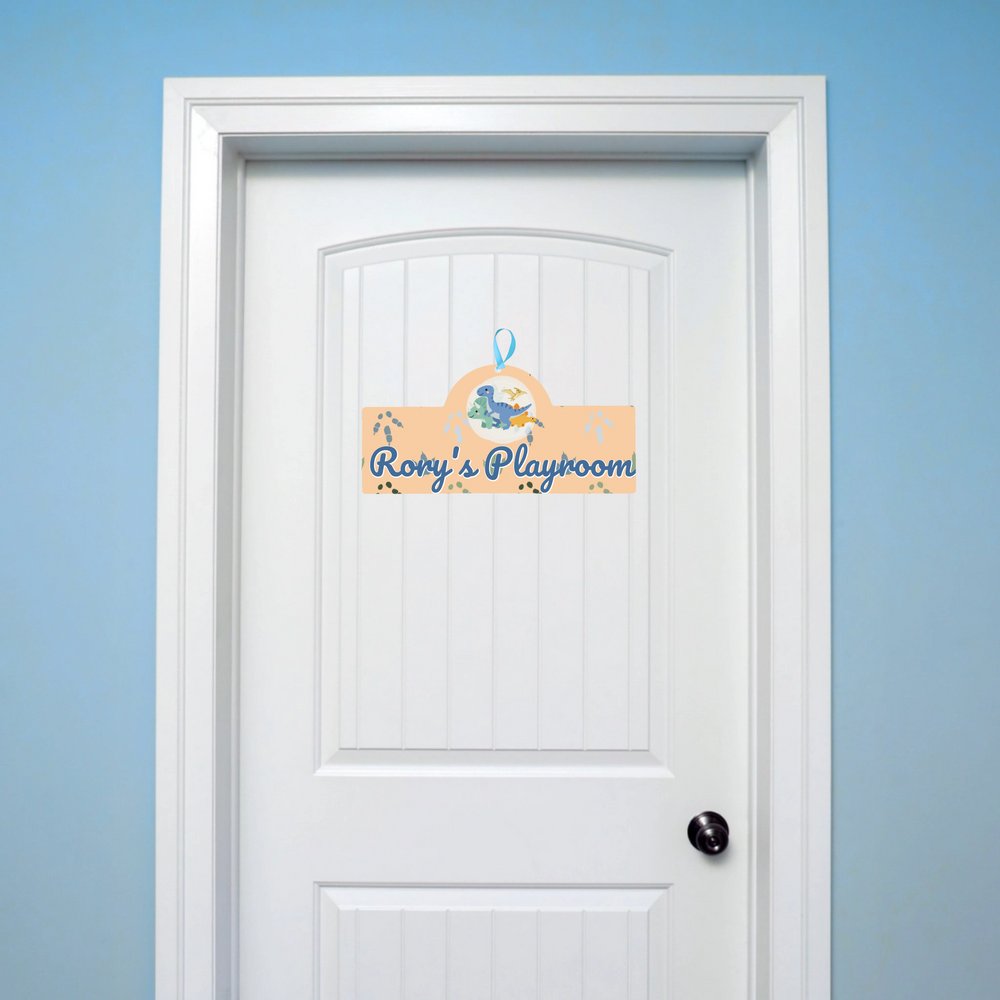 White door with a decorative sign reading 'Rory's Playroom' on a light blue background