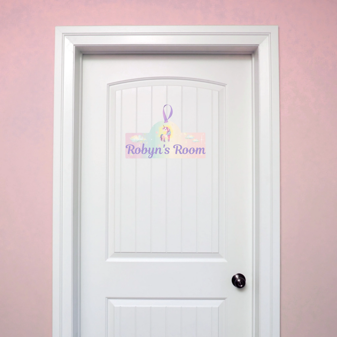White door with personalized sign on a pink wall