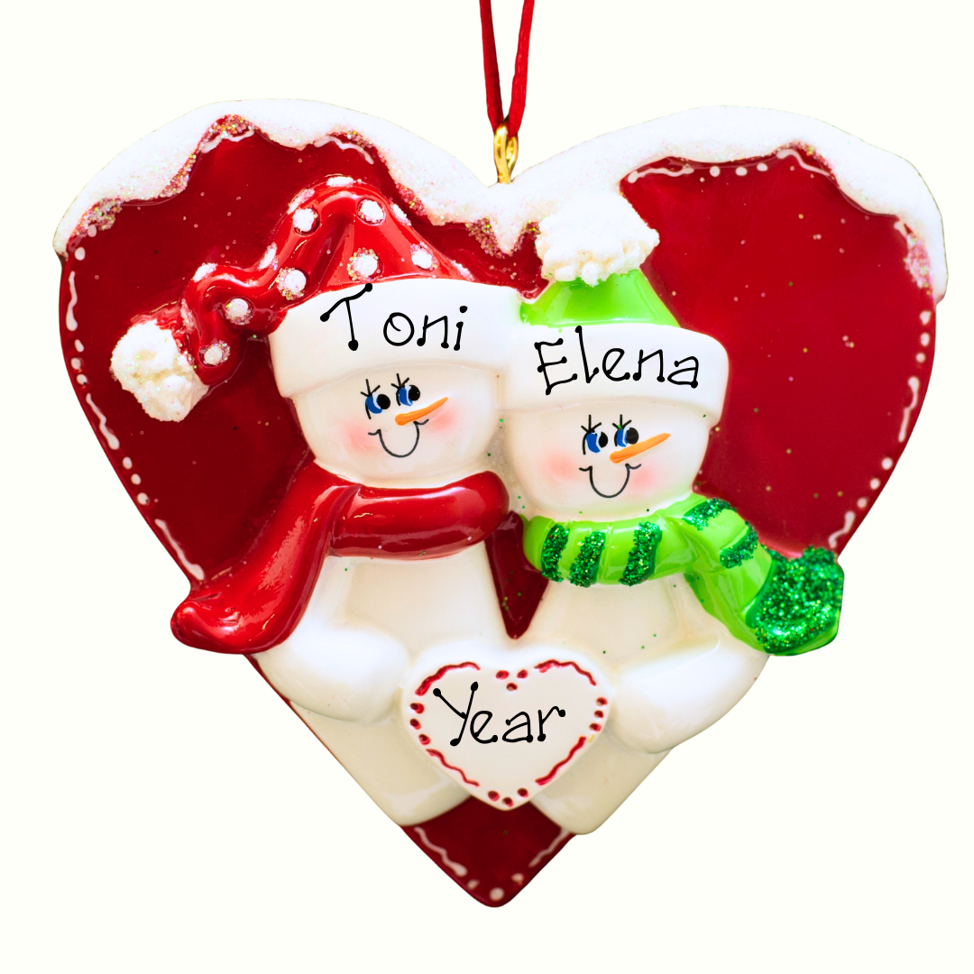 Heart-shaped Christmas ornament with two snowmen and a red heart background