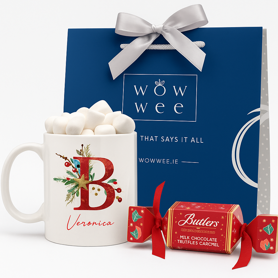 White mug with red letter 'B' and name 'Veronica', blue gift box with white bow, and Butlers chocolate bars on a white background.